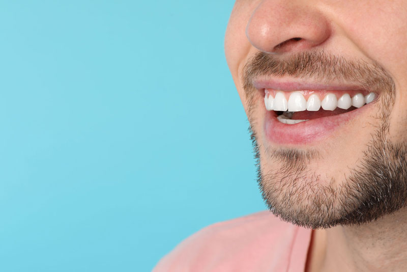dental patient smiling after crown lengthening procedure